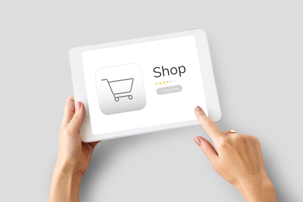 Hands holding a tablet showing an online store
