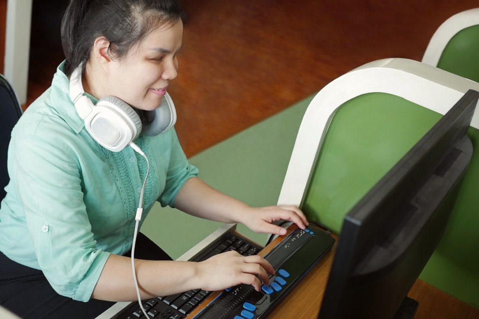 blind woman using an assistive device