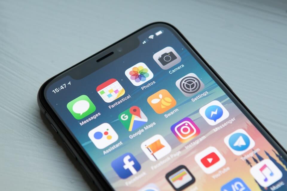 iPhone screen with various mobile apps for different businesses