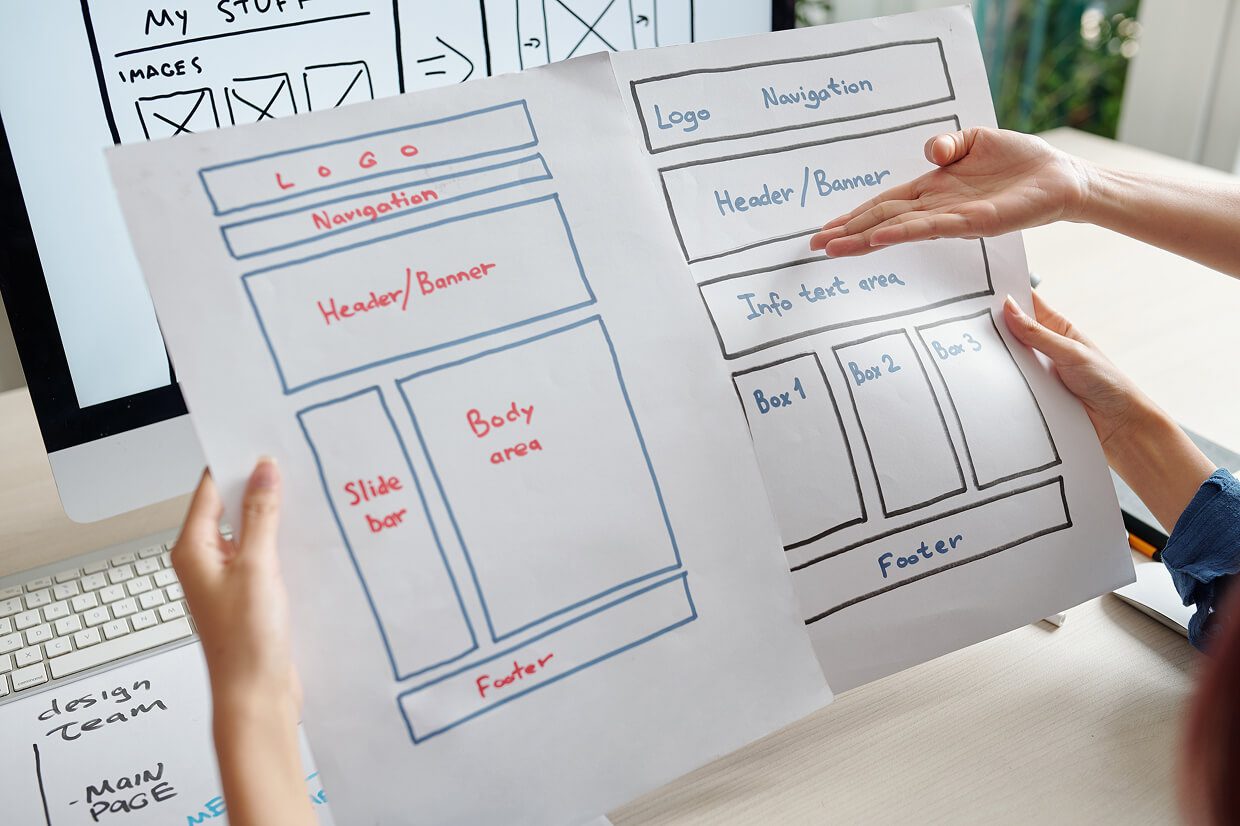 people holding paper. mockups of a website