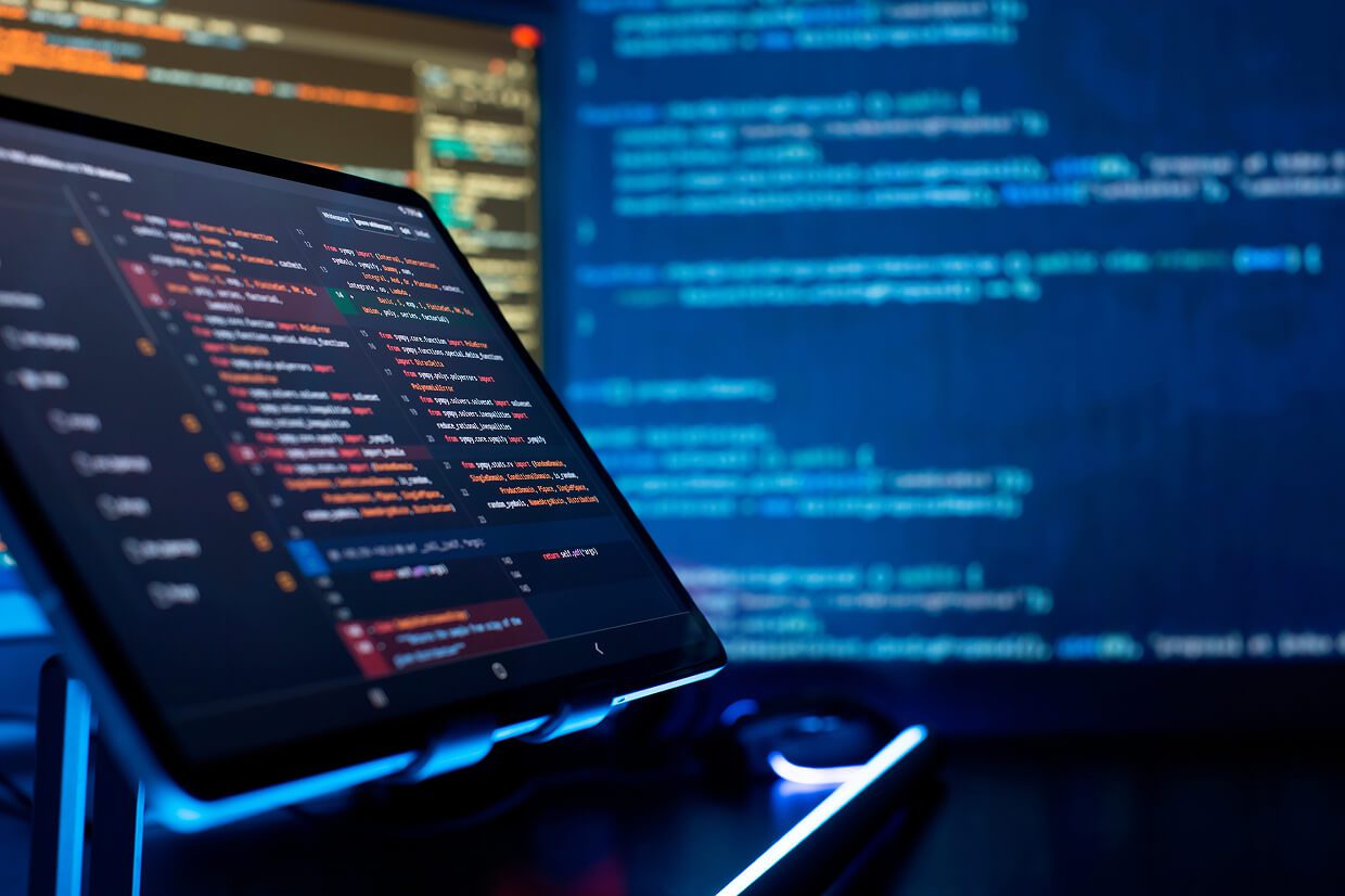 2 monitors showing codes