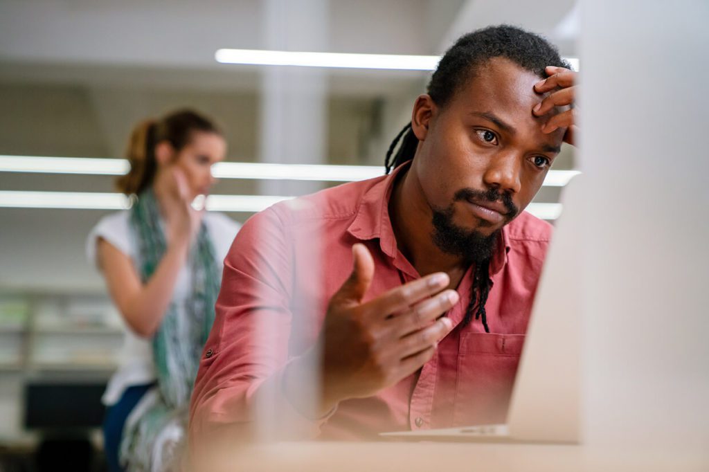Male seen looking at screen