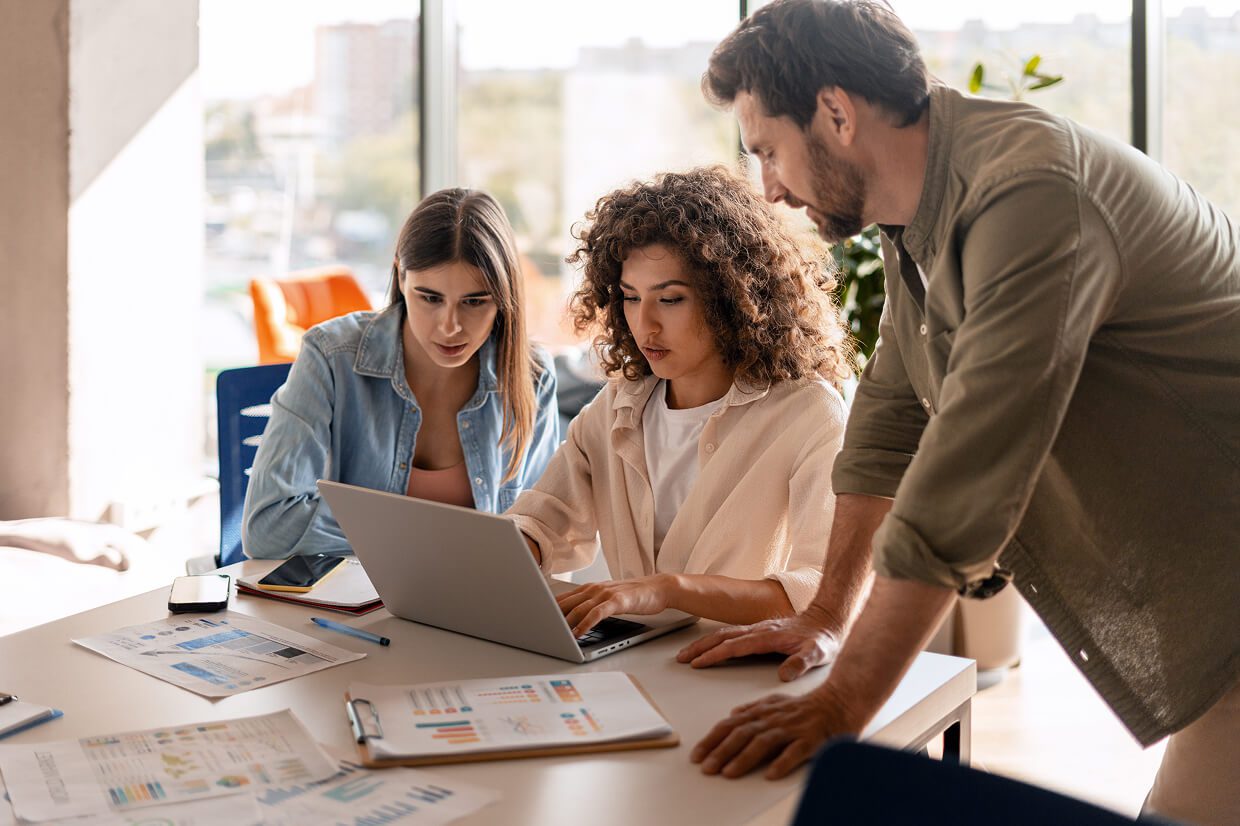 3 People looking at a laptop screen