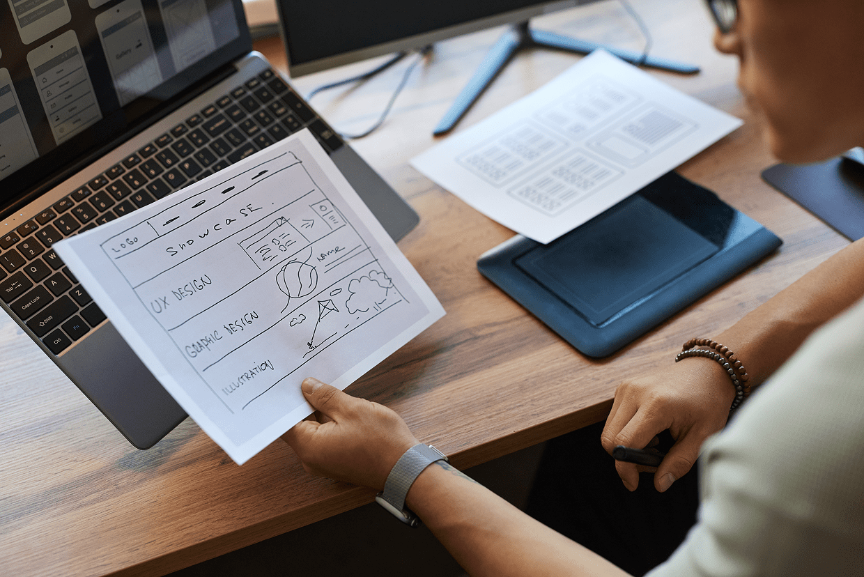 Laptop, charts, desktop and mousepad on a desk