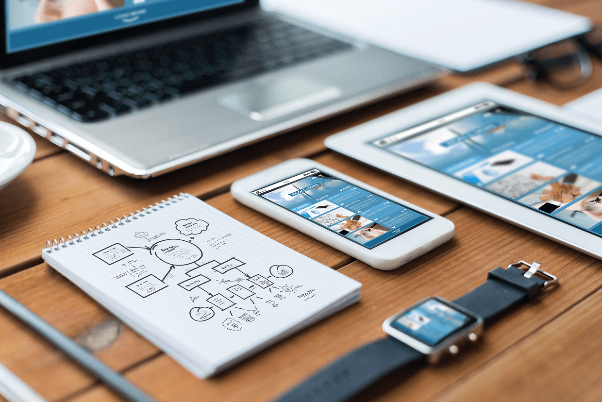 Watch, phone, tablet and laptop on a table