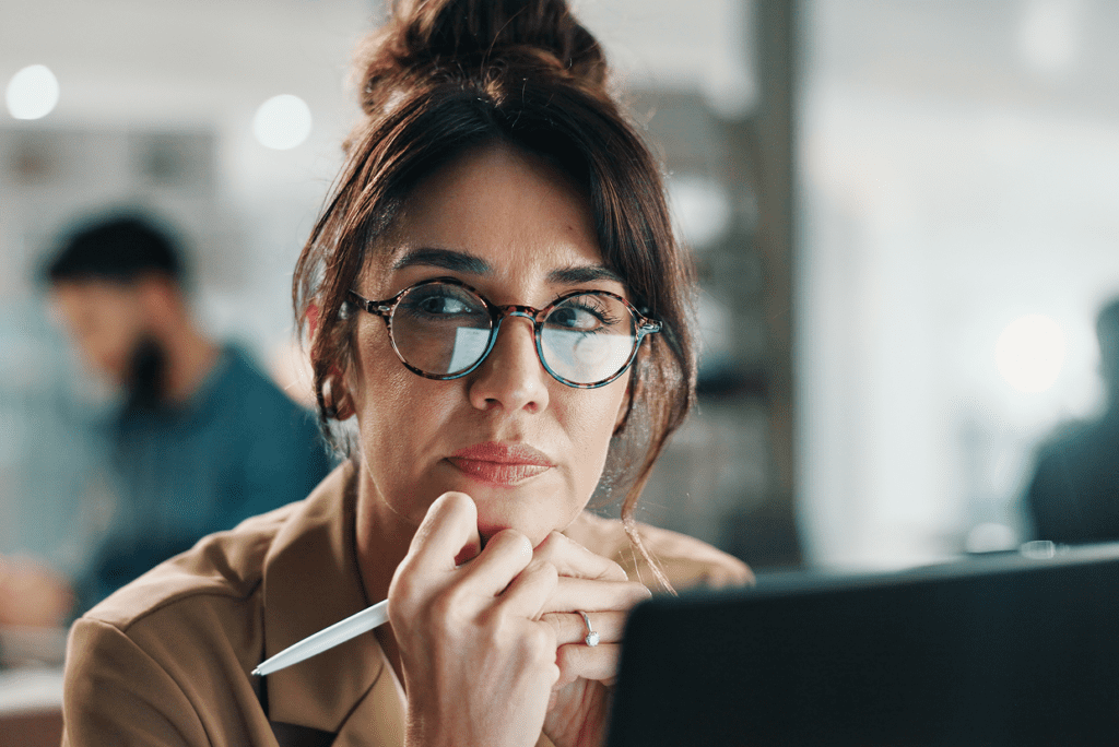 Female with computer pen glancing away from the screen