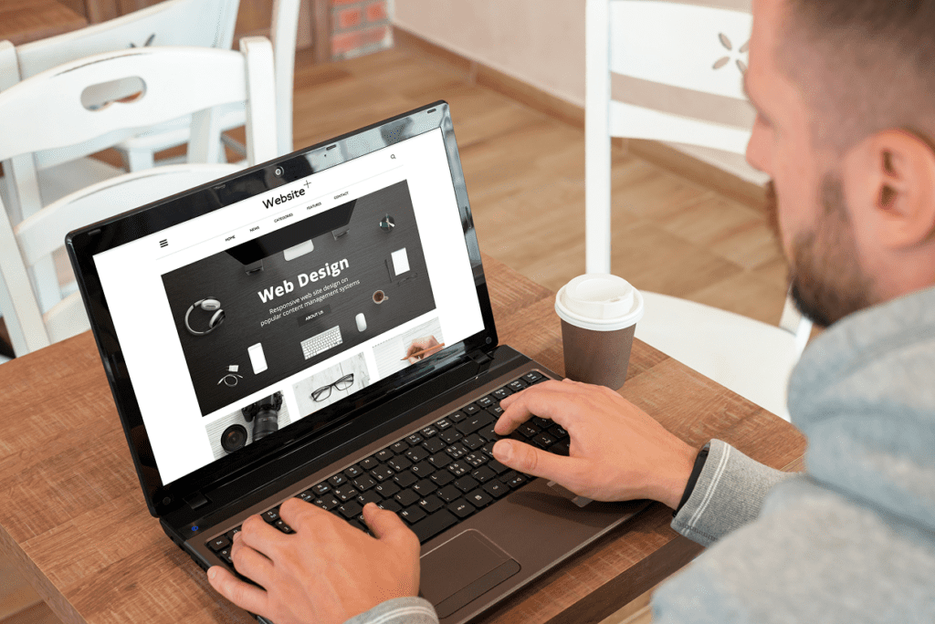 Male looking at screen with the words web design and website