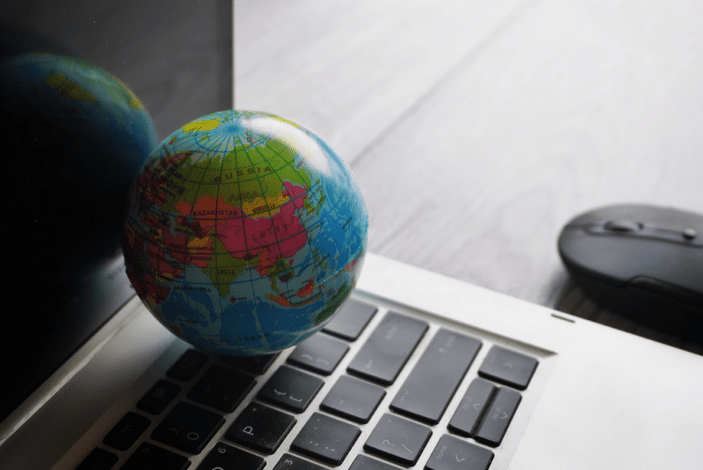 Globe on a keyboard with a mouse next to it