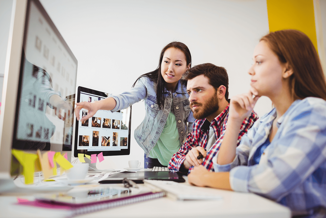 3 individuals staring at a computer screen