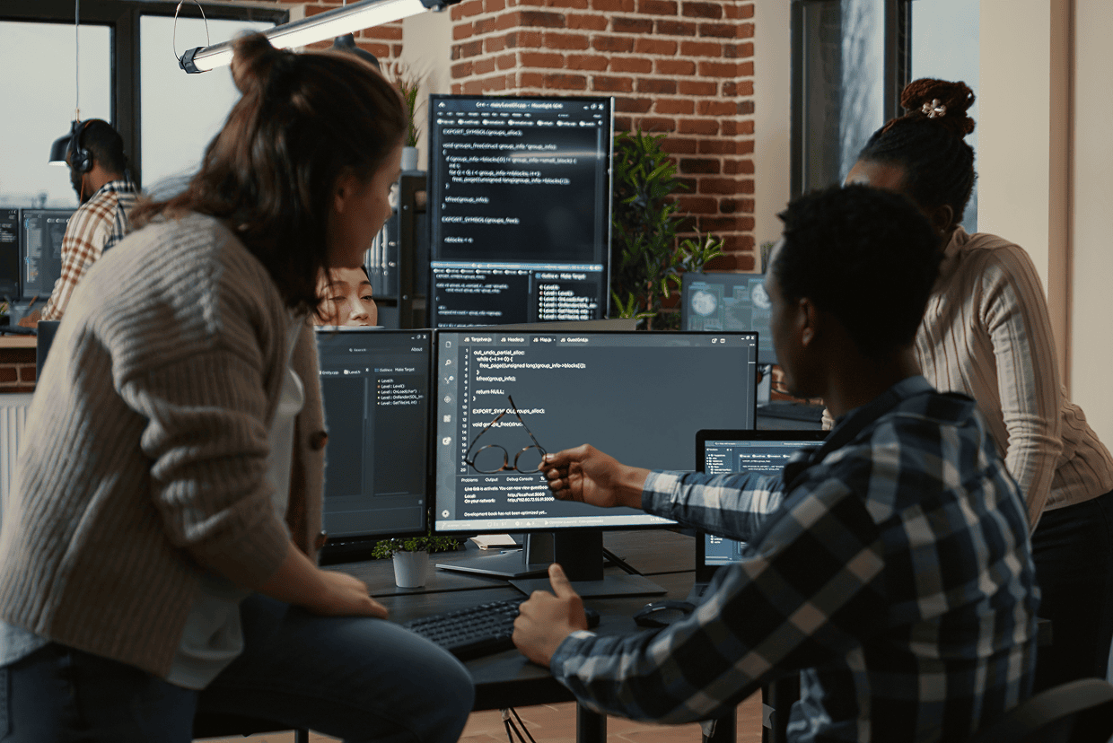 Group gathered around a table looking at a computer screen